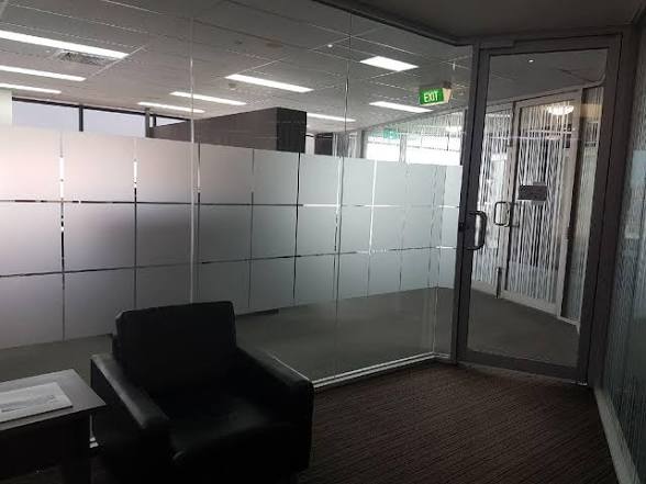 Frosted glass privacy screening beside an office reception area